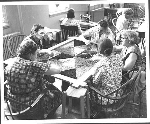 A view of 5 people working on a project in an occupational therapy session at the state hospital in the 1960s.