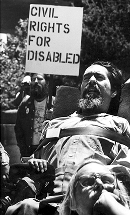 Ed Roberts in a crowd of others demonstrating outside the San Francisco Federal building.