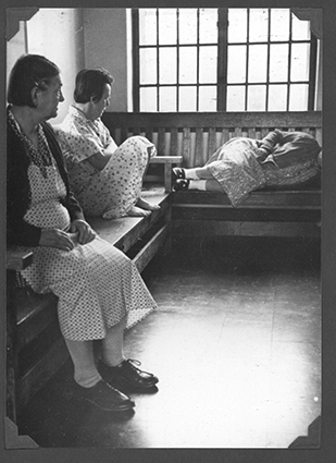 A view of 3 people in a ward at the state hospital in the 1960's.